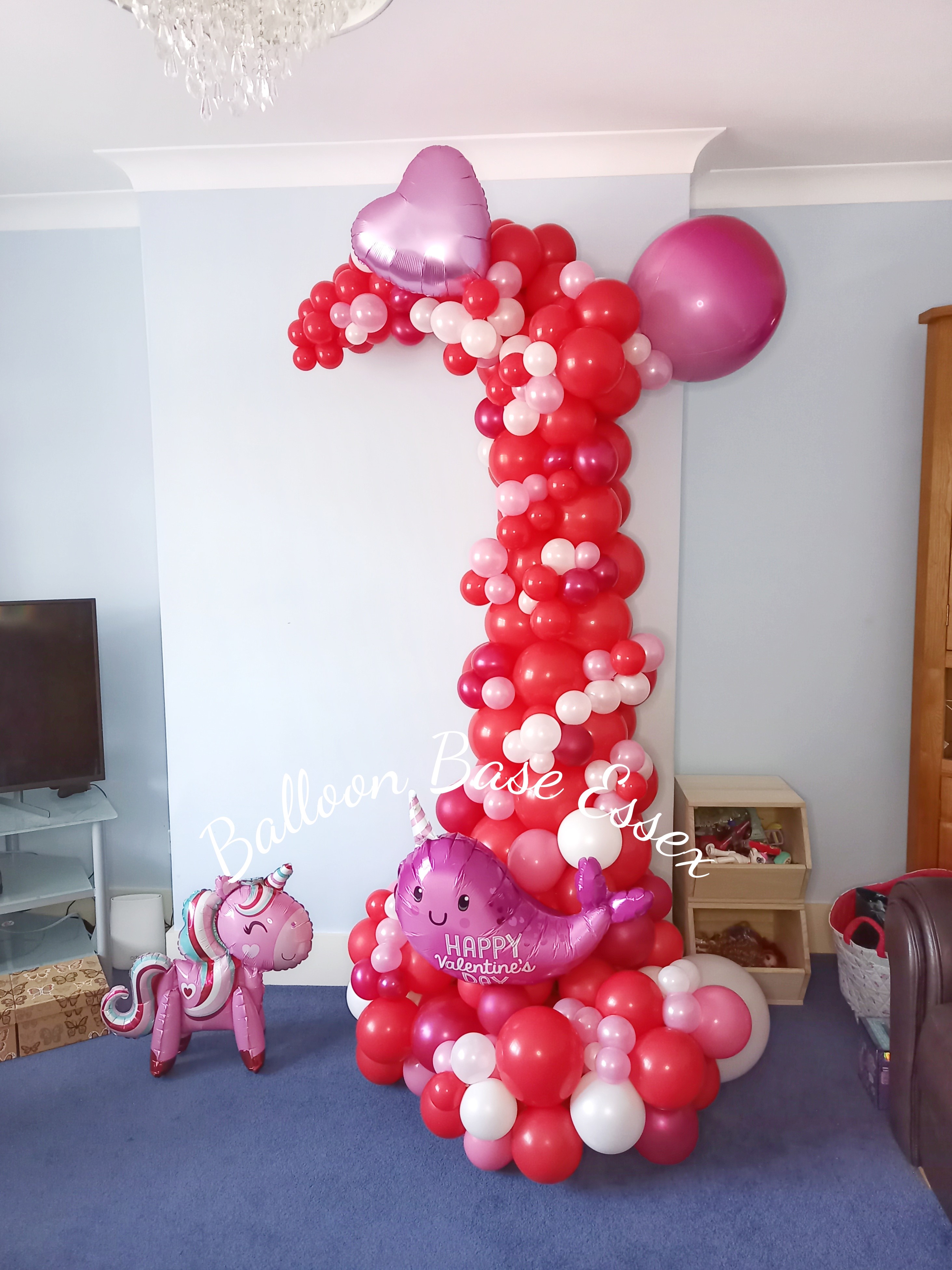 Cute Valentine's Day arch Arch made from red, pink and white balloons with Valentine's unicorn and narwhal balloons
